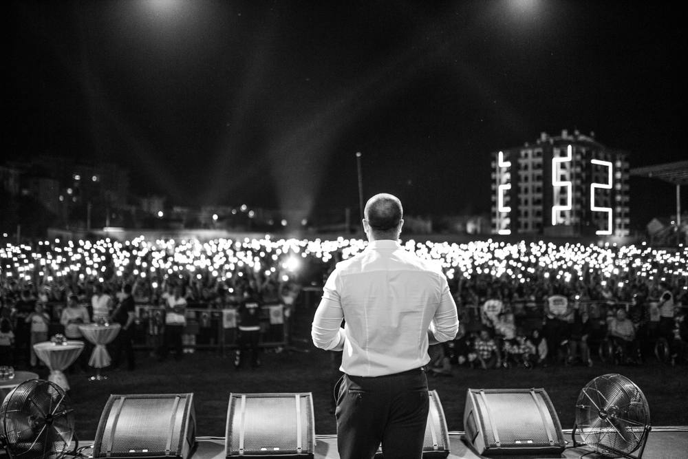 Speaker on stage in front of a large crowd